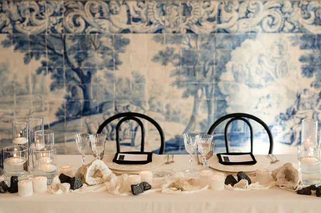 Wedding table with candles, crystals, and blue tiled wall