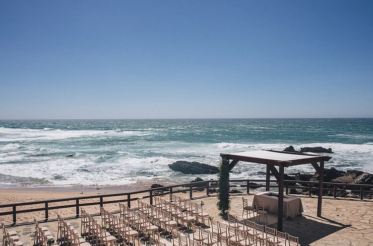 Wedding ceremony setup by the ocean in Portugal.