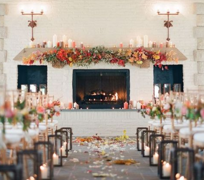 Fireplace with autumn garland, candles, and lanterns