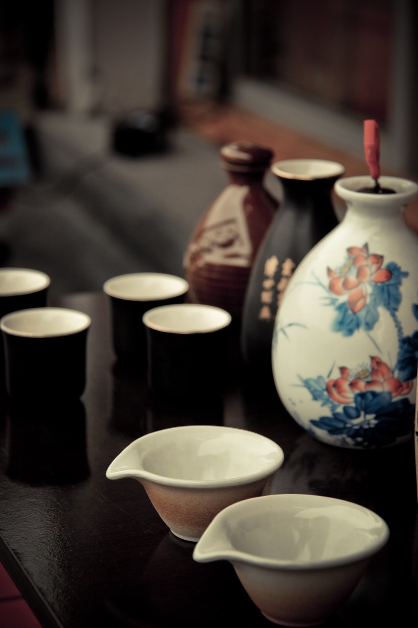 Sake bottles and cups on a dark wooden table